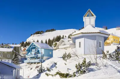 a small town with a church in the snow at Les Chalets de Flaine Hameau - maeva Home - Chalet 5 Pièces 8 Personnes - Prestige MAE-3655 in Flaine