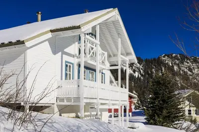 a white house with snow on the ground at Les Chalets de Flaine Hameau - maeva Home - Chalet 7 Pièces 12 Personnes - Sélection MAE-3656 in Flaine