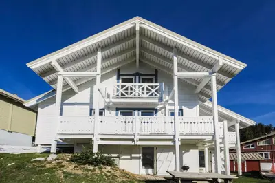 a white house with a balcony on a hill at Les Chalets de Flaine Hameau - maeva Home - Chalet 7 Pièces 12 Personnes - Sélection MAE-3656 in Flaine