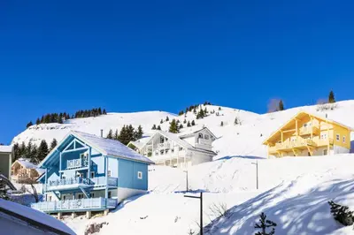 a group of houses in the snow at Les Chalets de Flaine Hameau - maeva Home - Chalet 7 Pièces 12 Personnes - Sélection MAE-3656 in Flaine