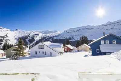 a village covered in snow with mountains in the background at Les Chalets de Flaine Hameau - maeva Home - Chalet 5 Pièces 8 Personnes - Confort MAE-3661 in Flaine