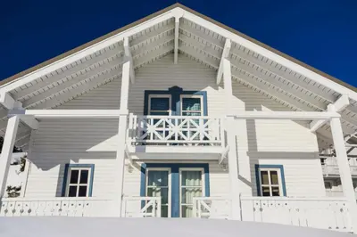 a white house with a porch at Les Chalets de Flaine Hameau - maeva Home - Chalet 5 Pièces 8 Personnes - Confort MAE-3661 in Flaine
