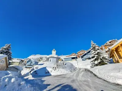 a village covered in snow with a church at Les Chalets de Flaine Hameau - maeva Home - Chalet 5 Pièces 8 Personnes - Confort MAE-3661 in Flaine