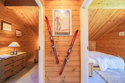 a bedroom with skis hanging on the wall at Les Chalets de Flaine Hameau - maeva Home - Chalet 5 Pièces 8 Personnes - Confort MAE-3661 in Flaine