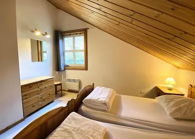 a bedroom with two beds and a window at Les Chalets de Flaine Hameau - maeva Home - Chalet 4 Pièces 8 Personnes - Confort MAE-3662 in Flaine