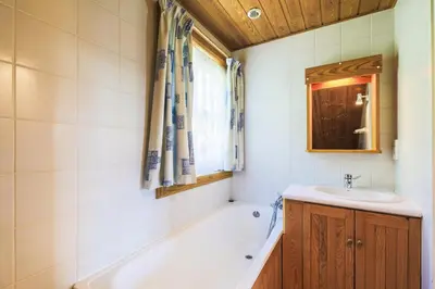 a bathroom with a bath tub and a sink at Les Chalets de Flaine Hameau - maeva Home - Chalet 4 Pièces 8 Personnes - Confort MAE-3662 in Flaine