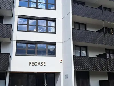a facade of a building with the words peace at Résidence Pégase - maeva Home - Appartement 3 Pièces 8 personnes - Sélection MAE-3663 in Flaine