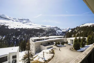 a building with a snow covered mountain in the background at Résidence Pégase - maeva Home - Studio 4 Personnes - Budget MAE-3664 in Flaine