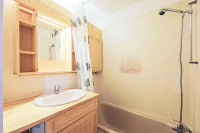 a bathroom with a sink and a bath tub at Résidence Arche - maeva Home - Appartement 2 Pièces 6 Personnes - Confort MAE-3694 in Arâches-la-Frasse