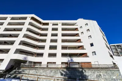 a white apartment building against a blue sky at Résidence Arche - maeva Home - Appartement 2 Pièces 6 Personnes - Confort MAE-3694 in Arâches-la-Frasse