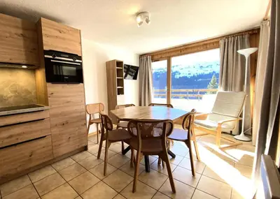 a kitchen and dining room with a table and chairs at Résidence Arche - maeva Home - Appartement 2 Pièces 6 Personnes - Confort MAE-3694 in Arâches-la-Frasse