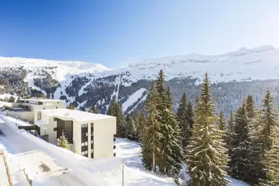 a building on top of a snowy mountain with trees at Résidence Arche - maeva Home - Studio 4 Personnes - Confort MAE-3695 in Arâches-la-Frasse