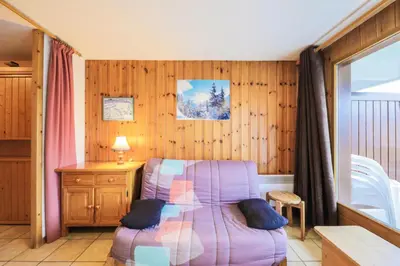 a room with a purple chair and a table and a desk at Résidence Arche - maeva Home - Studio 4 Personnes - Confort MAE-3695 in Arâches-la-Frasse