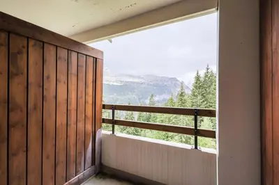 a balcony with a large window and a view of the mountains at Résidence Arche - maeva Home - Appartement 2 Pièces 6 Personnes - Confort MAE-3696 in Arâches-la-Frasse