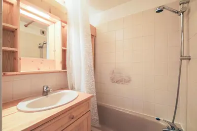 a bathroom with a sink and a tub and a mirror at Résidence Arche - maeva Home - Studio 4 Personnes - Confort MAE-3697 in Arâches-la-Frasse