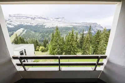 a window with a bench looking out at the mountains at Résidence Arche - maeva Home - Studio 4 Personnes - Confort MAE-3697 in Arâches-la-Frasse