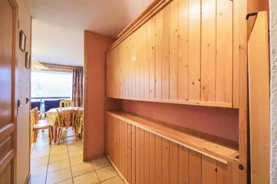 a kitchen with wooden cabinets and a dining room at Résidence Arche - maeva Home - Studio 4 Personnes - Confort MAE-3697 in Arâches-la-Frasse