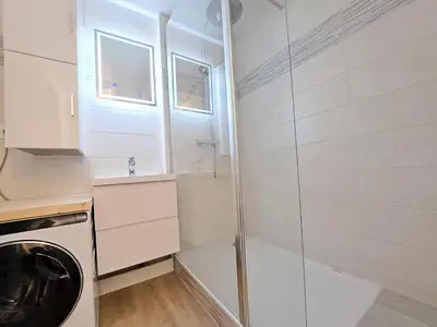 a bathroom with a shower and a washing machine at Résidence Aldébaran - maeva Home - Appartement 2 Pièces 6 Personnes - Prestige MAE-3791 in Arâches-la-Frasse