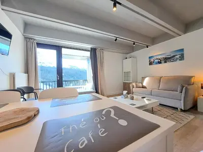 a living room with a fire code sign on a table at Résidence Aldébaran - maeva Home - Appartement 2 Pièces 6 Personnes - Prestige MAE-3791 in Arâches-la-Frasse