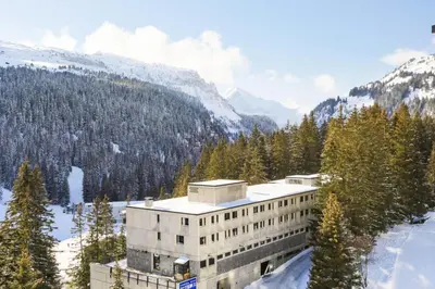 a building in the mountains with snow on the ground at Résidence Aldébaran - maeva Home - Appartement 2 Pièces 6 Personnes - Budget MAE-3792 in Arâches-la-Frasse