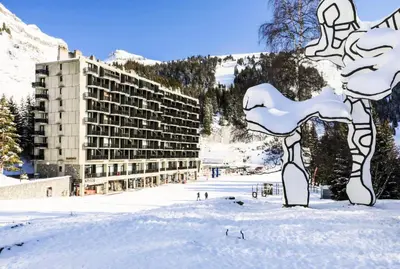a large building in the snow in front of a building at Résidence Aldébaran - maeva Home - Appartement 2 Pièces 6 Personnes - Budget MAE-3792 in Arâches-la-Frasse