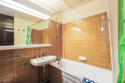 a bathroom with a sink and a bath tub at Résidence Aldébaran - maeva Home - Appartement 2 Pièces 6 Personnes - Budget MAE-3792 in Arâches-la-Frasse