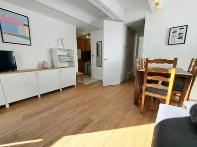 a living room with a dining table and a kitchen at Résidence Aldébaran - maeva Home - Studio 4 personnes - Confort MAE-3799 in Arâches-la-Frasse