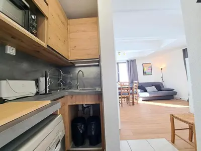 a kitchen with a sink and a living room at Résidence Aldébaran - maeva Home - Studio 4 personnes - Confort MAE-3799 in Arâches-la-Frasse