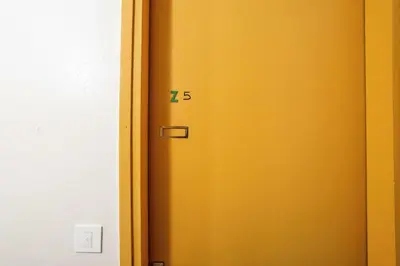 a yellow door with the number seventyfive on it at Résidence Aldébaran - maeva Home - Studio 4 personnes - Confort MAE-3799 in Arâches-la-Frasse