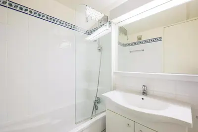 a white bathroom with a sink and a mirror at Résidence Aldébaran - maeva Home - Appartement 2 Pièces 6 Personnes - Confort MAE-3806 in Arâches-la-Frasse