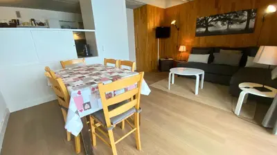 a kitchen and living room with a table and a couch at Résidence Aldébaran - maeva Home - Appartement 2 Pièces 6 Personnes - Confort MAE-3806 in Arâches-la-Frasse