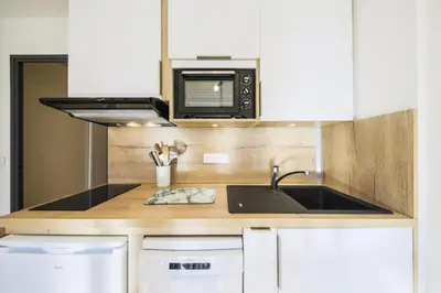 a kitchen with a sink and a microwave at Résidence Castor - maeva Home - Appartement 2 Pièces 6 Personnes - Confort MAE-3847 in Arâches-la-Frasse