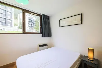 a bedroom with a white bed and a window at Résidence Castor - maeva Home - Appartement 2 Pièces 6 Personnes - Confort MAE-3847 in Arâches-la-Frasse