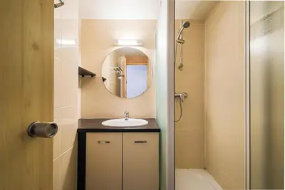 a bathroom with a sink and a mirror and a shower at Résidence Castor - maeva Home - Appartement 2 Pièces 6 Personnes - Confort MAE-3847 in Arâches-la-Frasse