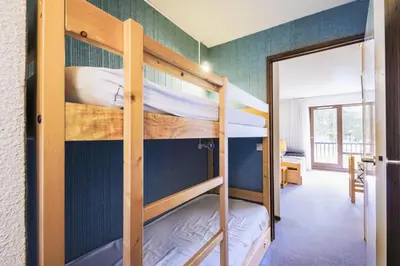 a bunk bed room with two bunk beds and a doorway at Résidence Castor - maeva Home - Appartement 2 Pièces 6 Personnes - Confort MAE-3850 in Arâches-la-Frasse