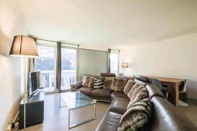 a living room with a leather couch and a table at Résidence La Petite Ourse - maeva Home - Appartement 4 Pièces 6 Personnes - Sélection MAE-3904 in Arâches-la-Frasse
