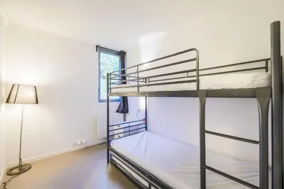 a bedroom with two bunk beds and a lamp at Résidence La Petite Ourse - maeva Home - Appartement 4 Pièces 6 Personnes - Sélection MAE-3904 in Arâches-la-Frasse