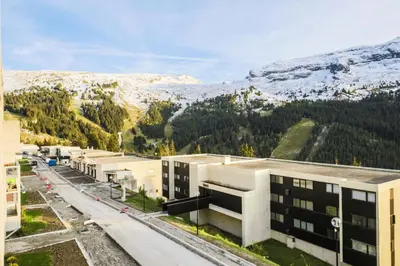 an aerial view of a building in front of a mountain at Résidence La Petite Ourse - maeva Home - Appartement 4 Pièces 6 Personnes - Sélection MAE-3904 in Arâches-la-Frasse