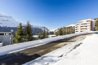 a road covered in snow with mountains in the background at Résidence Doris - maeva Home - Studio 4 Personnes - Confort MAE-3910 in Arâches-la-Frasse
