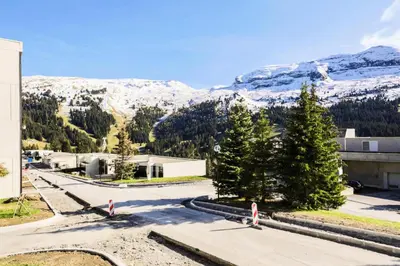 a building with trees and mountains in the background at Résidence Doris - maeva Home - Studio 4 Personnes - Confort MAE-3910 in Arâches-la-Frasse