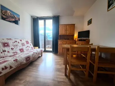 a living room with a couch and a table and a television at Résidence Doris - maeva Home - Studio 4 Personnes - Confort MAE-3910 in Arâches-la-Frasse