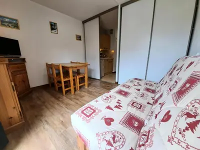 a living room with a bed and a table at Résidence Doris - maeva Home - Studio 4 Personnes - Confort MAE-3910 in Arâches-la-Frasse