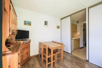 a kitchen with a table and a dining room at Résidence Doris - maeva Home - Studio 4 Personnes - Confort MAE-3910 in Arâches-la-Frasse