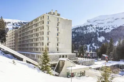 a building in the snow in front of a mountain at Résidence Cassiopée - maeva Home - Appartement 2 Pièces 6 Personnes - Sélection MAE-3948 in Arâches-la-Frasse