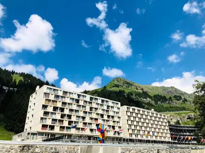 a hotel building with a mountain in the background at Résidence Cassiopée - maeva Home - Appartement 2 Pièces 6 Personnes - Sélection MAE-3948 in Arâches-la-Frasse
