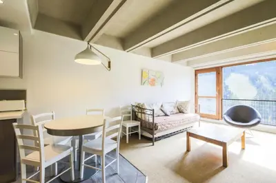 a living room with a table and a couch at Résidence Cassiopée - maeva Home - Appartement 2 Pièces 6 Personnes - Sélection MAE-3948 in Arâches-la-Frasse