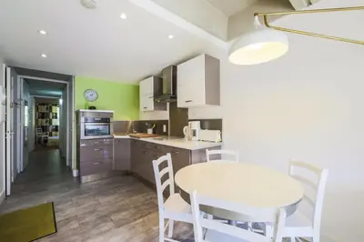 a kitchen with a table and chairs in a room at Résidence Cassiopée - maeva Home - Appartement 2 Pièces 6 Personnes - Sélection MAE-3948 in Arâches-la-Frasse