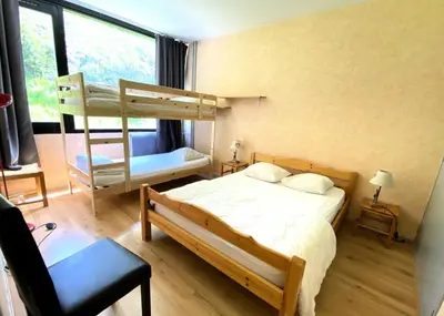 a bedroom with two bunk beds and a chair at Résidence Eridan - maeva Home - Appartement 5 Pièces 10 Personnes - Confort MAE-3955 in Flaine