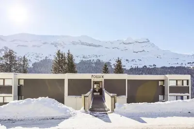 a building with a bunch of snow in front of it at Résidence Pollux - maeva Home - Appartement 2 pièces 6 personnes - Budget MAE-4210 in Arâches-la-Frasse