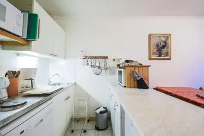 a kitchen with white cabinets and a counter top at Résidence Pollux - maeva Home - Appartement 2 pièces 6 personnes - Budget MAE-4210 in Arâches-la-Frasse